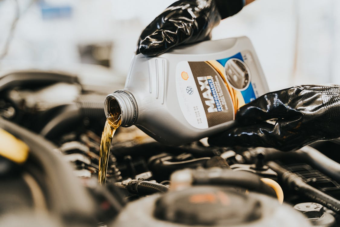 an up-close view of oil being poured in a vehicle